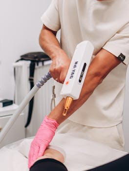 A professional performing laser hair removal treatment in a modern clinic environment.